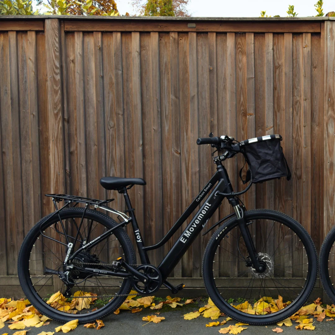 Black step-through electric bike with city handlebars and a rear rack