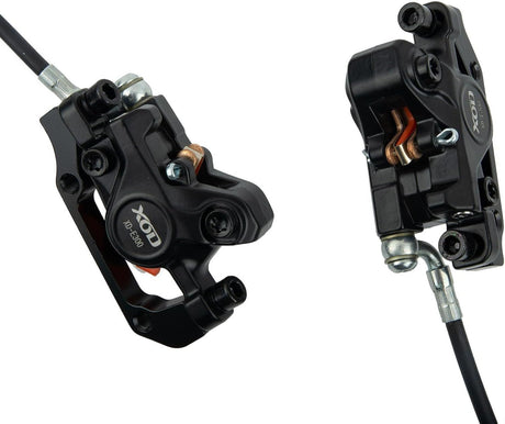 Two black brake calipers with visible branding